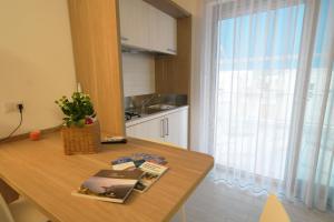 a kitchen with a wooden table and a window at Casa Dante Bed&Breakfast in Mattinata