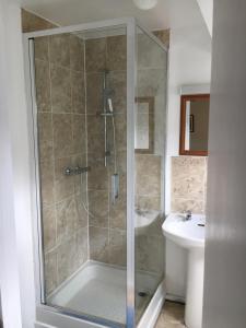 a bathroom with a shower and a sink at The Lampet Arms in Banbury