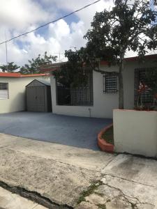 a house with a driveway in front of it at Joe Apartment in San Juan
