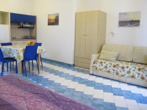 a living room with a couch and a table at Aparthotel Villa Marinù in Ischia