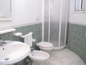 a bathroom with a sink and a toilet and a shower at Aparthotel Villa Marinù in Ischia