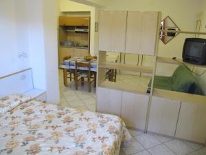 a bedroom with a bed and a tv in a room at Aparthotel Villa Marinù in Ischia