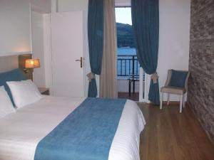 Postel nebo postele na pokoji v ubytování Mirini Hotel