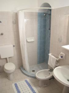 a bathroom with a shower and a toilet and a sink at Aparthotel Villa Marinù in Ischia