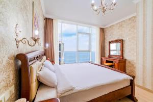 a bedroom with a large bed and a window at Apartment Pearl of Arcadia in Odesa +70 photos