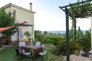 a patio with a table and chairs and a pergola at Argo Studios in Giosonas