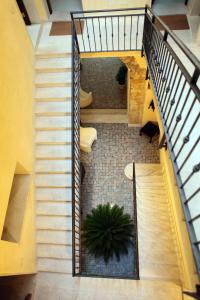 an overhead view of a staircase with a potted plant at Palazzo Ossuna in Trapani