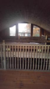 a room with a wooden fence and two windows at Sommerville Court Motel Bed & Breakfast in Lucknow