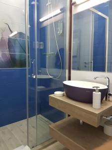 a bathroom with a sink and a glass shower at Apartment Panorama Summerland in Mamaia