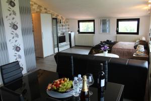 a living room with a couch and a table with a bowl of fruit at Villa Kimberly in Rovinj