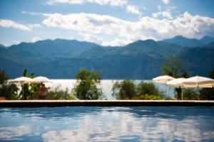 a swimming pool with a view of the mountains at Hotel Internazionale in Malcesine