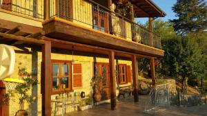a house with a balcony on top of it at CasaLambra Pedoulas Exclusive Accomodation Troodos Mountains in Pedoulas