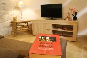 a book sitting on a table in a living room at L'insula in Scicli