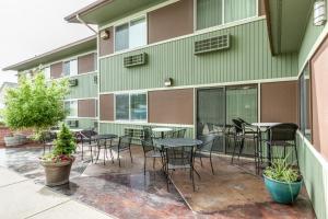 a patio with tables and chairs in front of a building at SureStay Plus Hotel by Best Western Post Falls in Post Falls