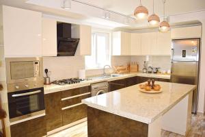 a large kitchen with a island in the middle at Villa Belvedere in Fethiye