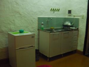 a small kitchen with a sink and a refrigerator at Panambi in Asunción