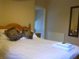 a dog laying on top of a bed in a bedroom at Kingsley Hotel in Bournemouth