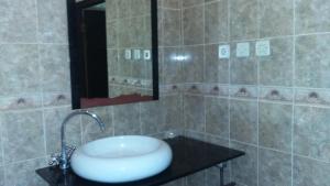 a bathroom with a sink and a mirror at Three Brothers Bobby's Villas in Amed