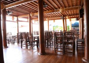 a room filled with wooden chairs and tables at Bac Ha Lake View in Bắc Hà +21 photos