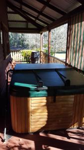 a pool table sitting on a screened in porch at Redgum Hill Country Retreat in Balingup
