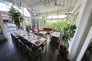 a room with a table and chairs and plants at THE CABANA in Sanur