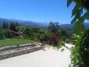 a path leading to a garden with mountains in the background at Chambres d'hôtes St Jacques Adults only in Saint-Lizier +13 photos