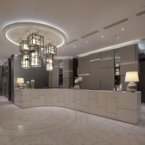 a lobby with a reception desk and chandeliers at Stanford Hotel Hong Kong in Hong Kong