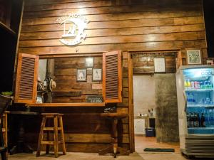 a restaurant with a counter and a refrigerator at Pai Homey in Pai