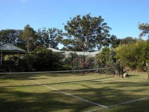 a tennis court with a tennis racket on it at Smoky Cape Retreat in South West Rocks