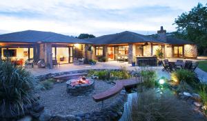 a backyard with a fire pit and a house at Conach House in Cambridge