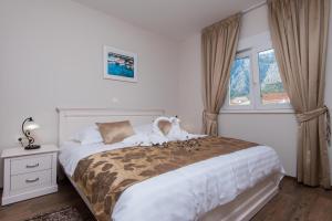 Posteľ alebo postele v izbe v ubytovaní Apartments Villa Stella + 37 fotografií