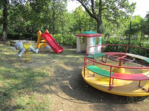 a playground with several different types of play equipment at Lodge Holidays - Glamping San Marino in San Marino