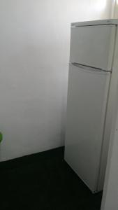 a white refrigerator in a corner of a room at Balaia Gardens, jardins da Balaia in Albufeira