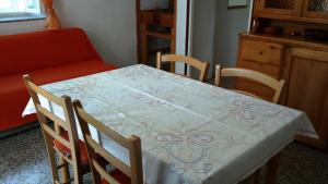 a table and chairs with a table and a couch at Apartments Princip in Orlec +16 photos