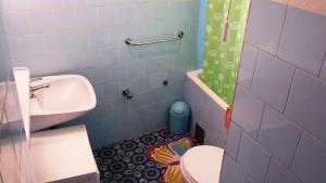 a blue bathroom with a toilet and a sink at Apartments Princip in Orlec