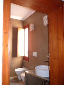 a bathroom with a tub and a toilet and a sink at Casabettina in Valderice +10 photos