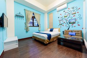 埔里にあるSeven Dwarfs Travel Stackの青い壁のベッドルーム1室、ベッド1台、椅子1脚が備わります。