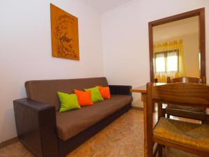 a living room with a couch with colorful pillows at Apartments Ivan 1408 in Banjole