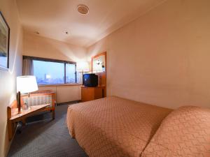 Una cama o camas en una habitación de Gunma Royal Hotel