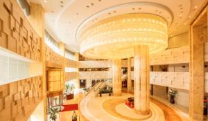 a large lobby with a large chandelier in a building at Soluxe Hotel Guangzhou in Guangzhou