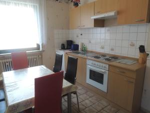 a kitchen with a table and a stove top oven at Ferienhaus Erika in Zorge