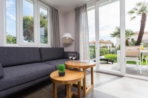 a living room with a couch and a table at Villa Velvet in Villeneuve-Loubet