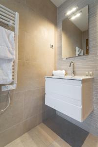 a bathroom with a sink and a mirror at Villa Velvet in Villeneuve-Loubet