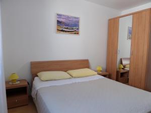 Postel nebo postele na pokoji v ubytování Apartmani Lili