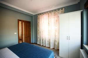 een slaapkamer met een bed, een kast en een raam bij Bliss Residence - Aquamarine in Constanţa