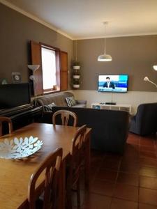 a living room with a table and a couch at Abrigo da Geira House in Campo do Gerês