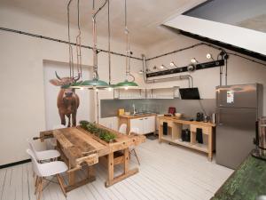 a kitchen with a table with a deer statue on it at Loft Sen Pszczoły in Warsaw