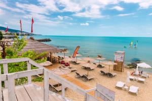 a beach with umbrellas and chairs and the ocean at Oxygen Apartments in Sveti Vlas
