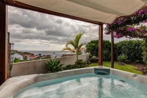 a bath tub with a view of the ocean at epicenter SANTACRUZ in Lagoa