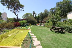 a playground with a picnic table and a park bench at Ashdot Yaacov Ichud Kibbutz Country Lodging in Ashdot Ya‘aqov